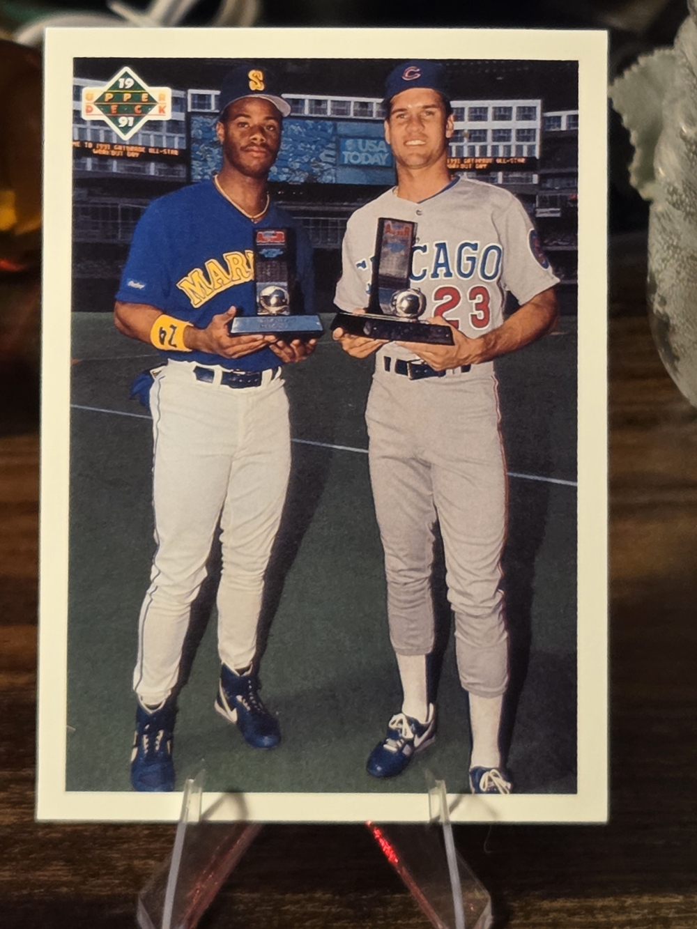 This image shows Ken Griffey Jr. and Ryne Sandberg holding trophies on a 1991.